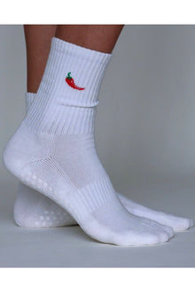  White socks with a red chili pepper design on a gray background