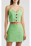 Green lace-up top and skirt set on a white background