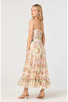 Woman shown from the back wearing a floral strapless midi dress on a white background. 