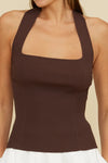 Brown ribbed tank top worn by a person on a beige background