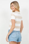 Woman wearing a striped shirt and denim shorts on a white background