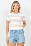 Woman wearing a striped shirt and denim shorts on a white background