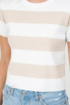 Beige and white striped shirt worn by a person with a blurred background