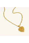 Gold necklace with a heart-shaped pendant on a white background. 