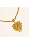 Close-up of gold necklace with a heart pendant on a white background. 