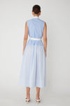 Woman shown from behind wearing a light blue and white striped midi dress with a white belt on a plain white background